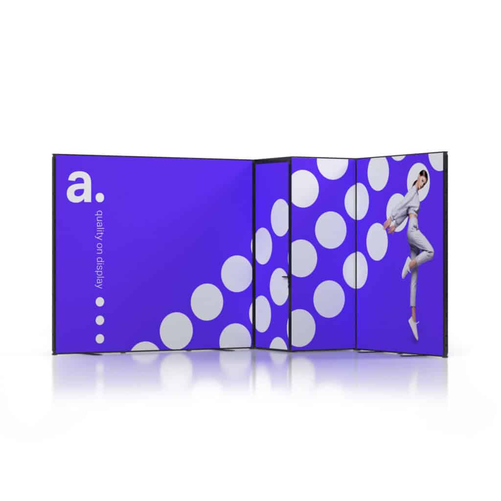 Beursstand Een vouwdisplay met een opvallende paarse achtergrond, grote witte stippen en een persoon in een lichte outfit en hoed die vrolijk springt op het rechterpaneel. Op het linkerpaneel staat een kleine letter a. en de verticale teksthelderheid op het display.